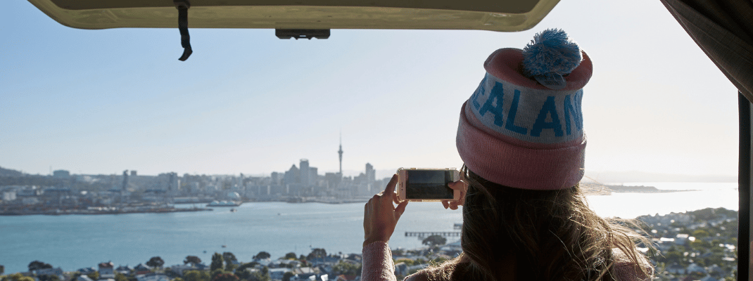 Taking a photo of Auckland Cityscape in Campervan